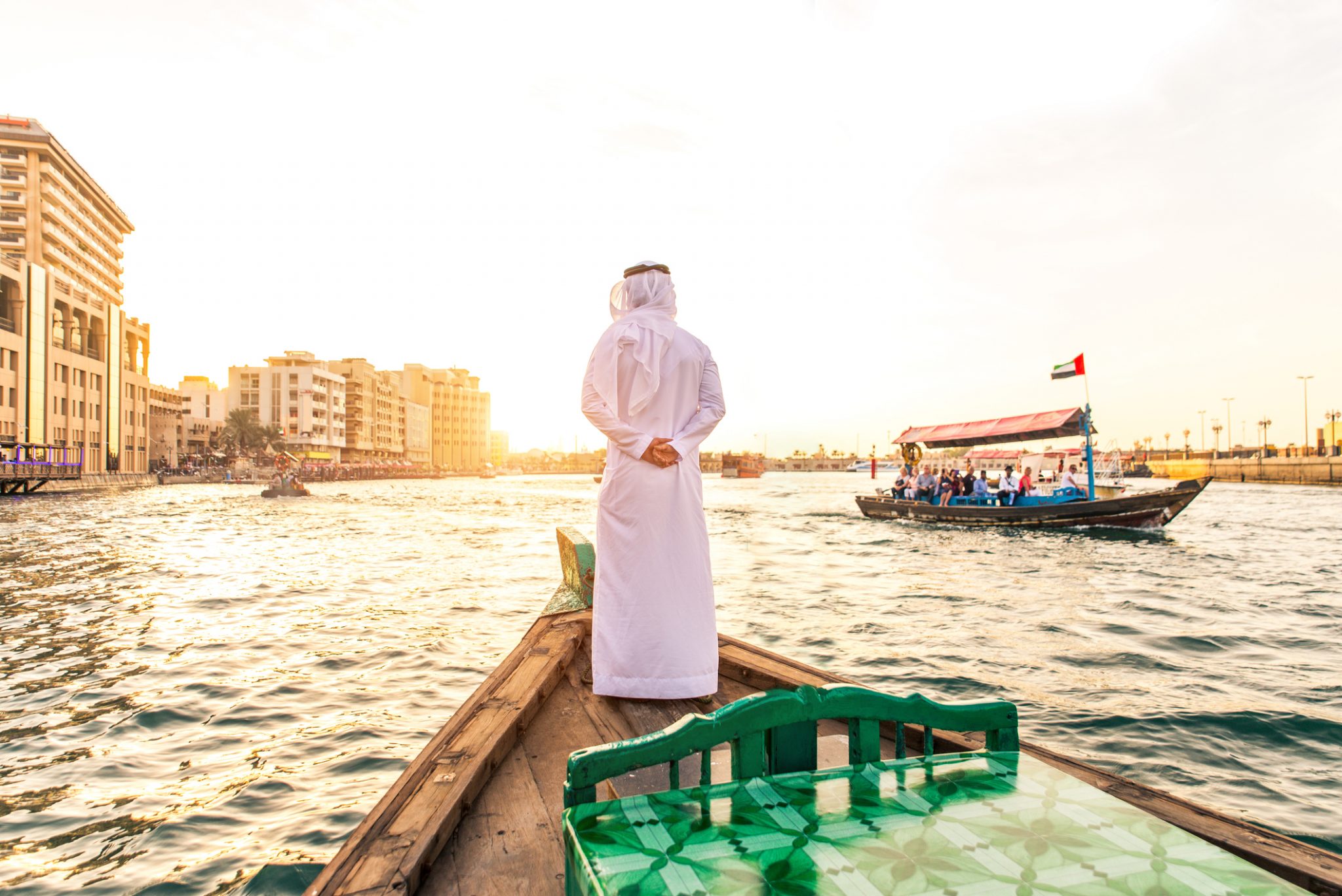 Arabian man on abra boat on Creek's canal
